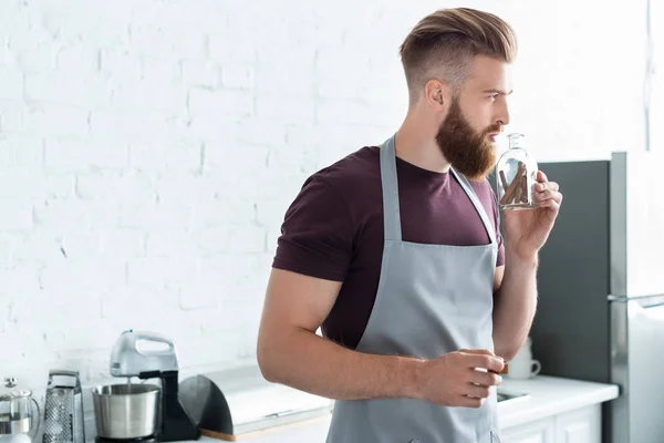 Handsome Bearded Young Man Apron Holding Container Cinnamon Sticks Kitchen — стоковое фото